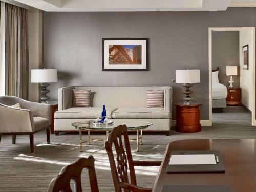 a living room with a couch and a table at Sonesta Hotel Gwinnett Place Atlanta in Duluth