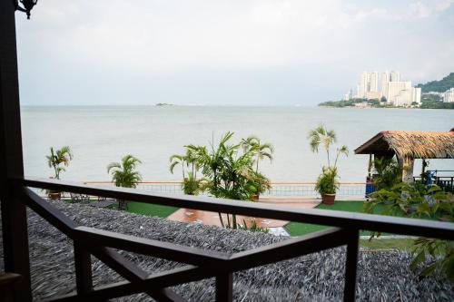 a view of the water from the balcony of a resort at Lost Paradise Resort in Batu Ferringhi
