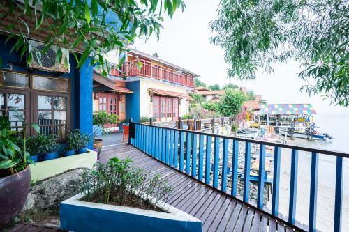 a balcony of a building with a view of the water at Lost Paradise Resort in Batu Ferringhi