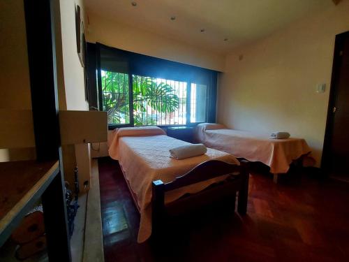 a room with two beds and a window at COYA HOSTEL in Salta