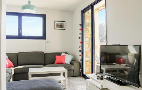a living room with a couch and a flat screen tv at Gorgeous Home In Saint-Germain-Sur-Ay in Saint-Germain-sur-Ay