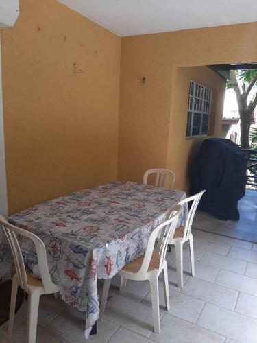 a dining room table with chairs and a quilt on it at Patmay Greenery. Fresh air, vacation get away. in Saint-James