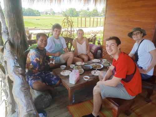 a group of people sitting around a table at Kakrona Pouk Homestay in Siem Reap