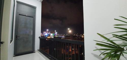 a balcony with a view of a city at night at Sun&Sea House Homestay in Quy Nhon