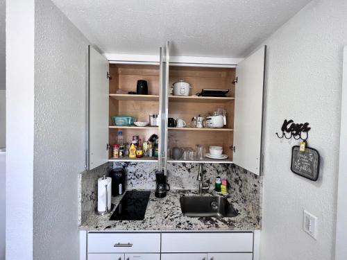 a kitchen with a sink and a counter at Stylish Studio Apartment By Miami International Airport in Miami