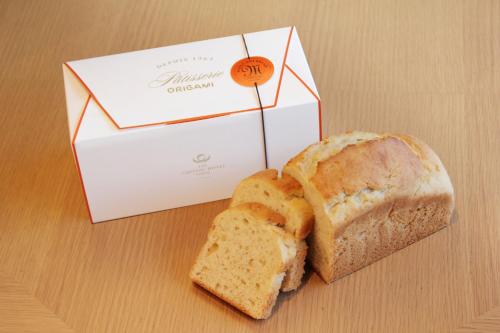 a loaf of bread next to a white box and a sandwich at The Capitol Hotel Tokyu in Tokyo