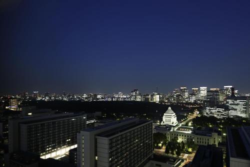 a view of a city skyline at night at The Capitol Hotel Tokyu in Tokyo