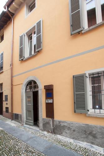 an orange building with a door and windows at Balbianino in Lenno