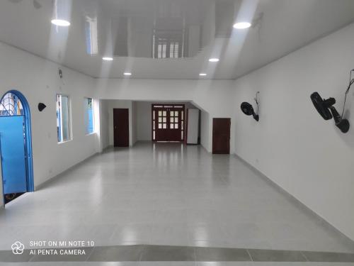an empty room with white walls and a door at Casa Hotel Victoria Real in Mariquita