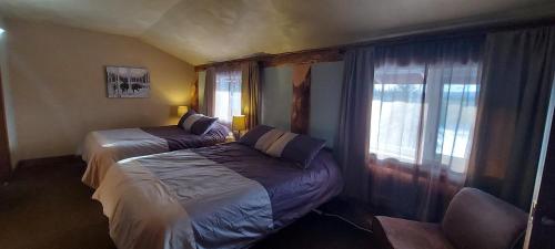 a hotel room with two beds and a window at Northern Sky Lodge in Fairbanks