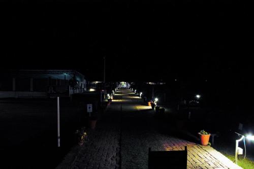 an empty street at night with lights on at Shivir Aranya - Wilderness Resort in Alwar
