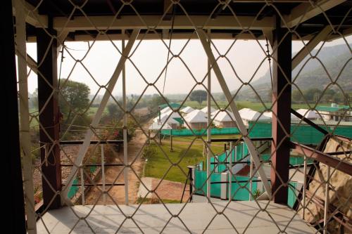 a view from the inside of a building with a window at Shivir Aranya - Wilderness Resort in Alwar