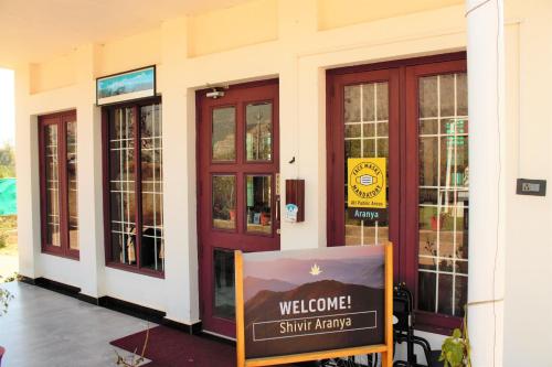 a welcome sign in front of a building at Shivir Aranya - Wilderness Resort in Alwar
