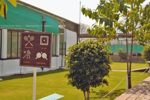 a sign in the grass in front of a building at Shivir Aranya - Wilderness Resort in Alwar