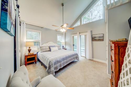 a bedroom with a bed and a ceiling fan at Fairway Getaway in Helen