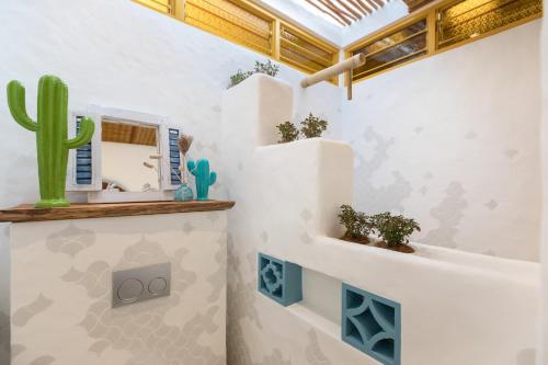 a room with a cactus and plants on a wall at Arkana Village Canggu by Nagisa Bali in Canggu