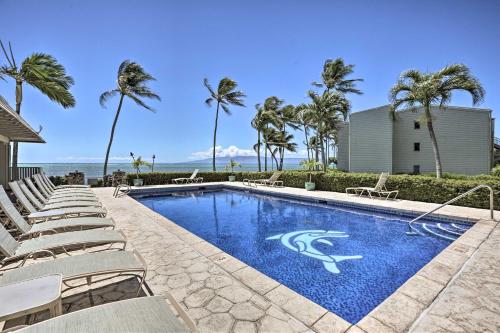 a swimming pool with lounge chairs and palm trees at Beach Access and Community Perks Hawaii Haven in Kaunakakai