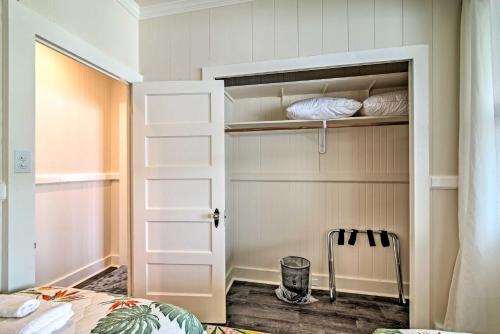 a walk in closet with a bed and a door at Papaikou Escape Less Than 3 Mi to Botanical Garden! in Papaikou