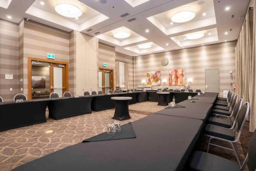 a conference room with a long table and chairs at Sandman Hotel Hamilton in Hamilton
