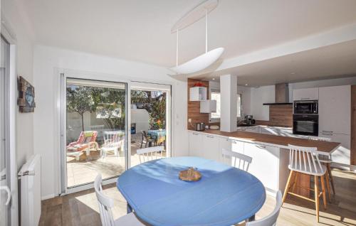 une cuisine et une salle à manger avec une table bleue dans l'établissement Holiday Home Canet Plage Bld De La Loge Sur Mer, à Canet