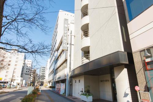 a building on a street in a city at Sankei City Hotel Chiba in Chiba