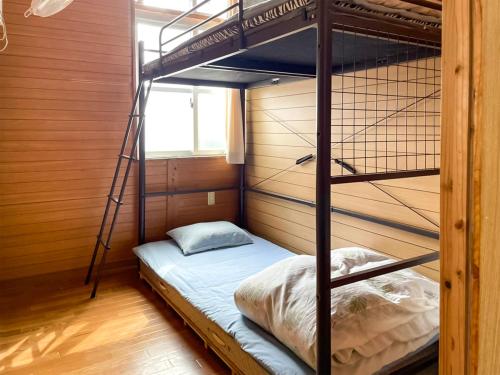 a bedroom with two bunk beds in a room at Emix Ishigaki in Ishigaki Island