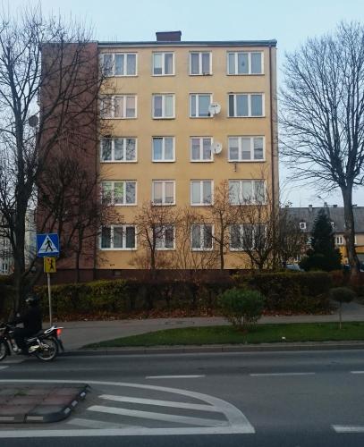 a large yellow building on the side of a street at MŁAWSKA 33 in Rypin