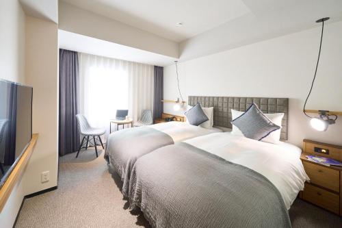 Un pat sau paturi într-o cameră la Hotel Resol Stay Akihabara