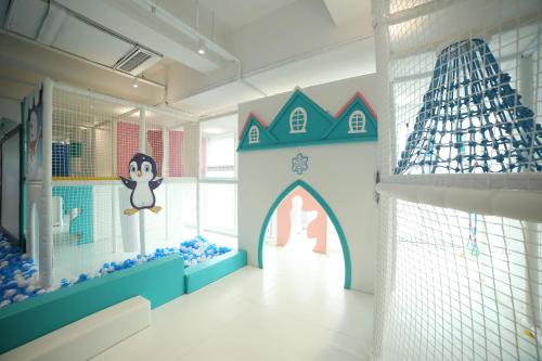 a childs room with a toy house on the wall at Grand Bay Hotel Chengdu in Chengdu
