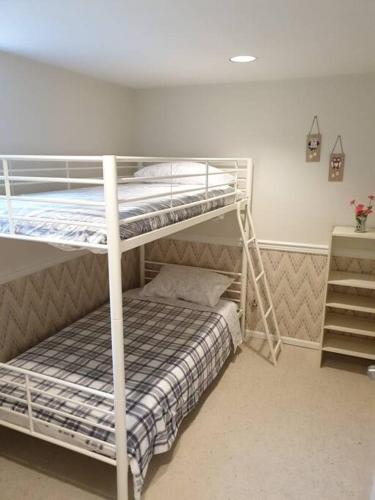 a bedroom with two bunk beds in a room at Happy, Cozy, Loving Guest Space in West Vancouver in West Vancouver