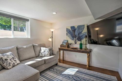 a living room with a couch and a table at 4 Mi to Coors Field Charming Apartment with Patio in Denver
