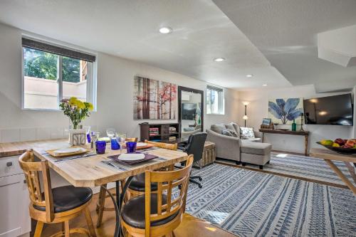 a kitchen and living room with a table and chairs at 4 Mi to Coors Field Charming Apartment with Patio in Denver