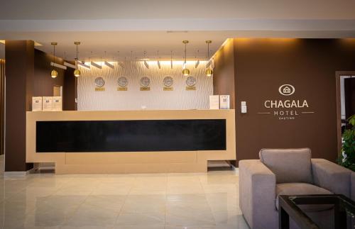 a lobby with a large flat screen tv in a building at Chagala Bautino Hotel in Bautino