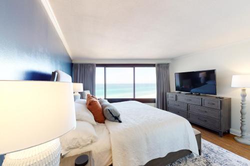 a bedroom with a large bed and a television at Beachside II #4293 in Destin