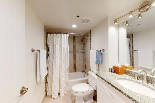 a white bathroom with a toilet and a sink at Beachside II #4293 in Destin