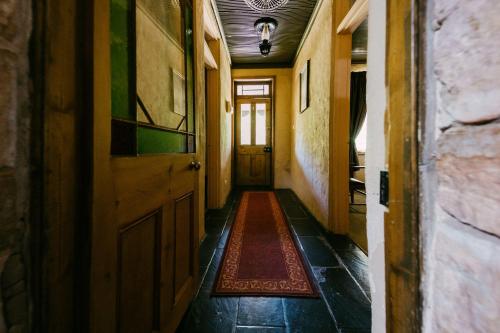 an empty hallway with a door and a rug on the floor at Mintaro Hideaway in Mintaro