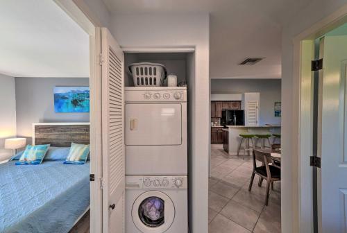 a room with a washer and dryer next to a bed at Waimea Condo Less Than 1 Mile from Mauna Lani Beach Club! in Waikoloa