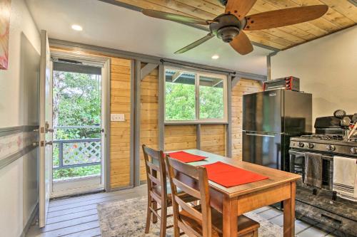 a kitchen with a wooden table and a refrigerator at Idyllic Pahoa Paradise Hike, Swim and Explore! in Pahoa