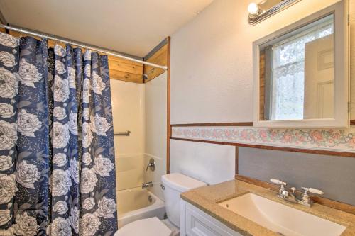 a bathroom with a sink and a toilet and a window at Idyllic Pahoa Paradise Hike, Swim and Explore! in Pahoa