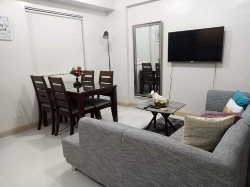 a living room with a couch and a table at Adel's Haven in Camella Northpoint in Davao City