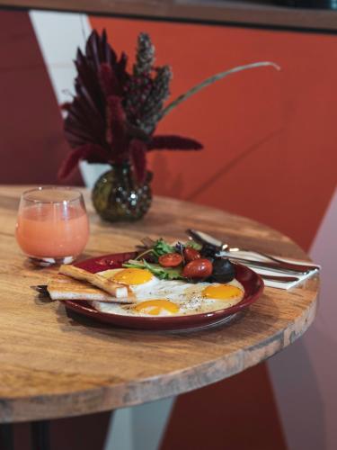 a plate of food with eggs and vegetables on a table at La Belle Ville in Paris