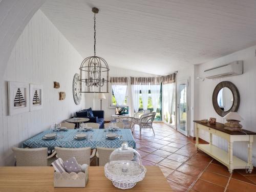 a dining room and living room with a table at Case Li Conchi Sardegna in Castiadas