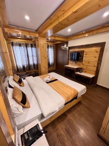 a bedroom with a large bed in a room at Hotel Victory in Shimla