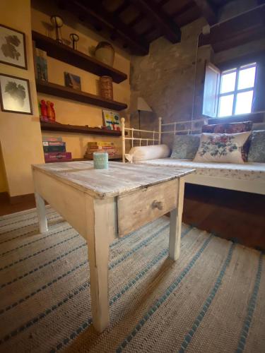 a wooden table in a room with a couch at Cal París Rural in La Donzell D'Urgell