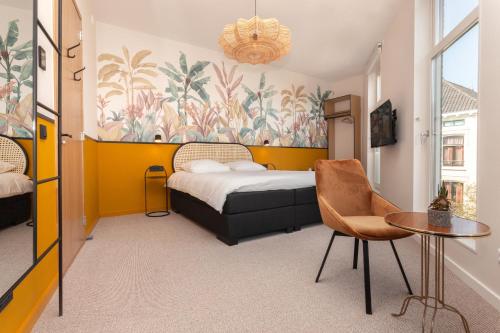 a hotel room with a bed and a table at La Paulowna Boutique Hotel in The Hague