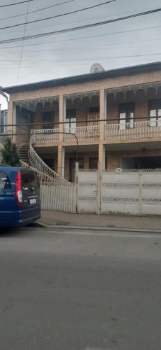 a blue car parked in front of a building at шорена in Batumi
