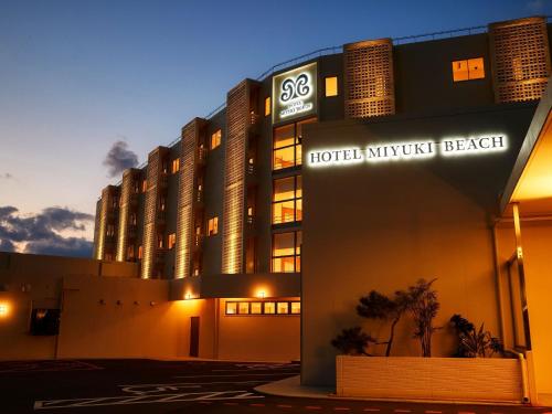 a hotel with a sign in front of a building at Hotel Miyuki Beach in Onna