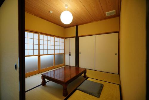 an empty room with a table and a window at Ryokoji Temple in Minami Aso