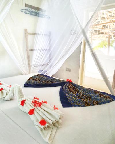 Postel nebo postele na pokoji v ubytování Blue Palm Zanzibar