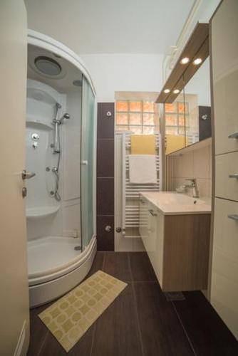 a bathroom with a shower and a sink and a tub at Boutique B&B Villa Carmen in Mlini